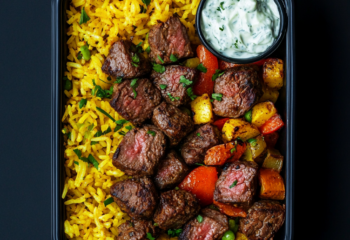 Steak Kebab Bites over Yellow Rice and Tzatziki Sauce