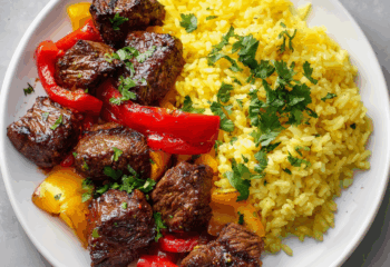 Garlic Butter Steak Bites with Roasted Vegetables and Saffron Rice